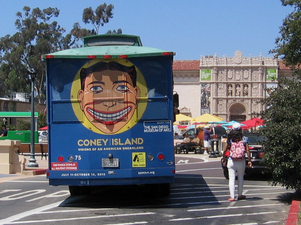 Grinning face of Tillie, symbol of Coney Island, on the back of a tour bus heading toward the San Diego Museum of Art in Balboa Park.