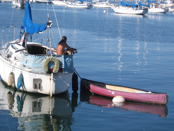 Fishing from sailboat moored in Crescent area of San Diego Bay.
