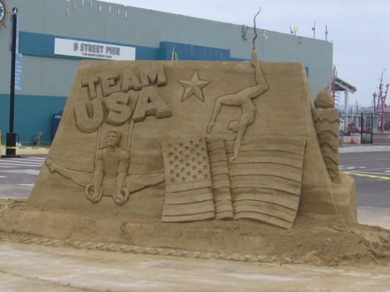 Team USA, American Olympic gymnasts and a United States flag decorates one side of a sand sculpture at the foot of the B Street Pier in San Diego!