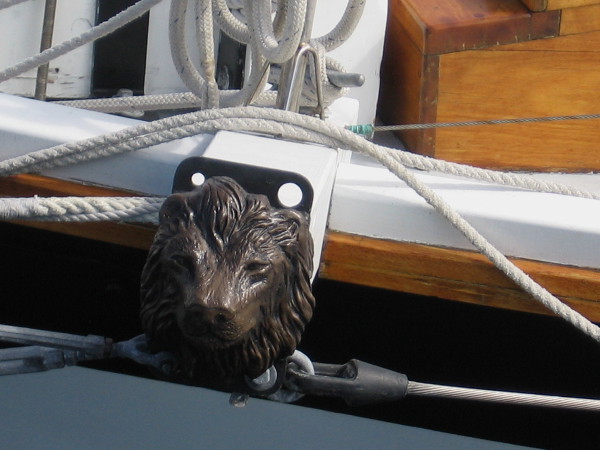 Lion's head decorates spar projecting from hull of topsail schooner Amazing Grace.