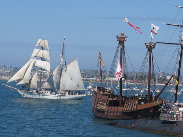 White sails, wooden ships, blue sky and living visions of maritime history.
