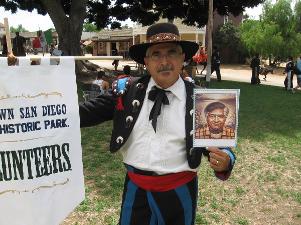 Many event participants carried photos and images of important Mexicans in history. This gentleman holds a tribute to activist Cesar Chavez.