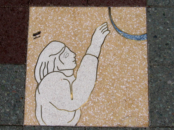 Reaching up toward the ring-like moon. Striving toward hopes and dreams.