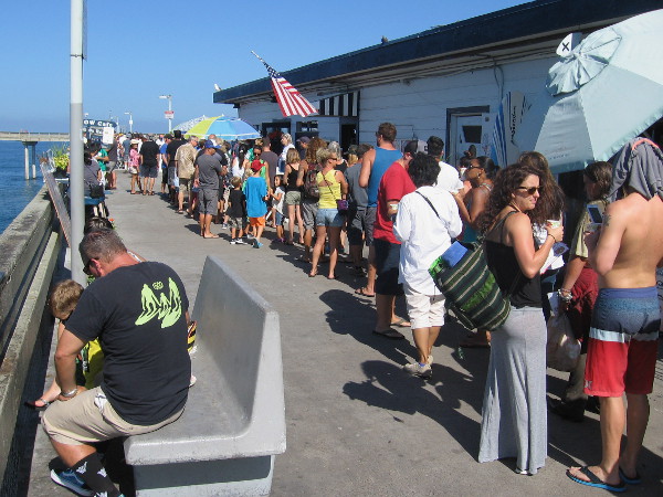 A long line of hungry folks waits near the much-beloved Ocean Beach pier cafe, which has been a cool place to go for many years.