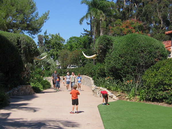 Two huge shrub elephants guard a path at the west edge of Spanish Village. Walk north and you'll arrive at the world famous San Diego Zoo!
