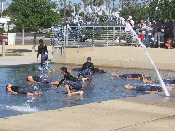 The dancers rise up as individuals, like living things emerging from primordial waters.