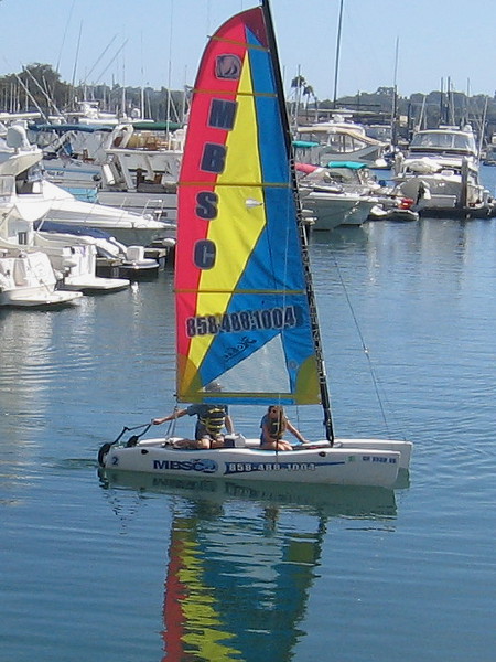 A colorful sail and reflection on smooth water at the Hyatt Regency Mission Bay Marina.