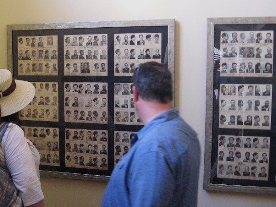 Visitors to The Headquarters old cell block look at mug shots on one wall.