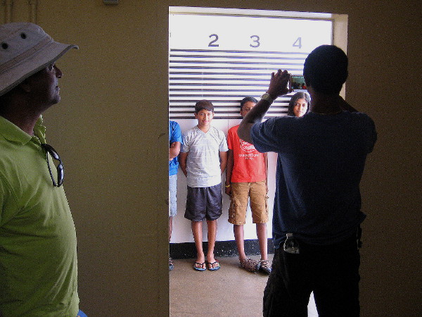 Kids are photographed at the lineup wall. They look slightly suspicious!
