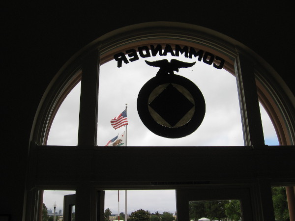 Looking from inside the Command Center southeast toward Preble Field and a large American flag.