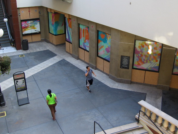 A few early evening visitors to Horton Plaza mall in downtown San Diego walk past cool artwork created by a local artist!