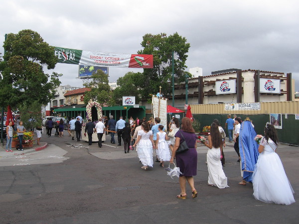 Approaching a banner announcing that next Sunday is Little Italy's popular neighborhood Festa.