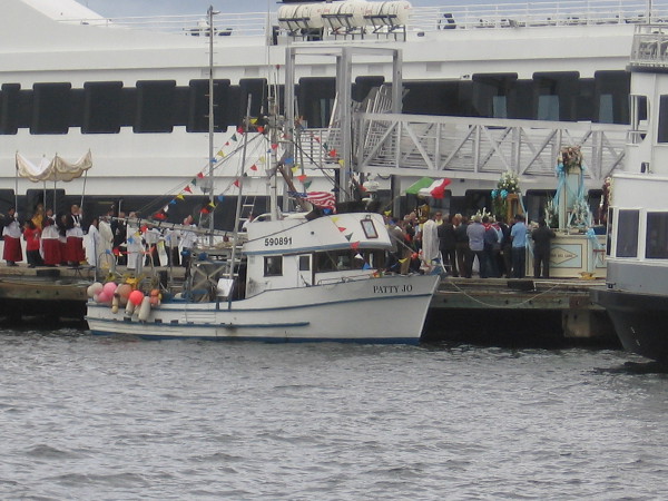 My camera could just catch a glimpse of the elaborate Catholic ritual beside the Patty Jo fishing boat.
