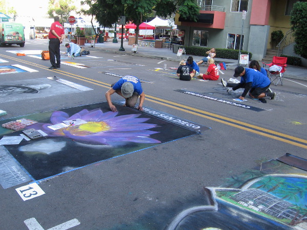 Before Festa opens, chalk artists work on their creations on two blocks of Beech Street in downtown San Diego.