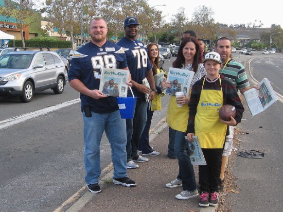 Smiling Chargers football players helping to raise money for kids included Sean Lissemore, nose tackle, and Tyreek Burwell, tackle. Everyone was having a great time!
