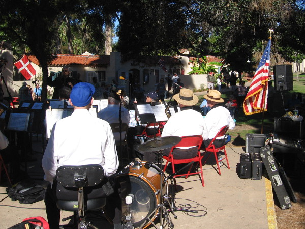 The band is ready to play as people gather around the stage in the lawn area of the International Cottages. It's a Sunday afternoon in San Diego's beautiful Balboa Park.