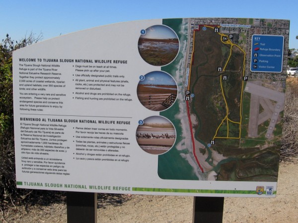 Sign welcomes visitors to Tijuana Slough National Wildlife Refuge. Five endangered and two threatened species of birds are protected here in their natural habitat.