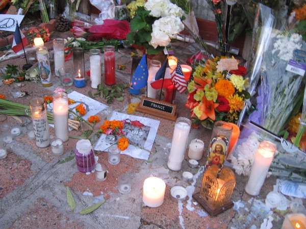 Candles remain lit the morning after the vigil. Signs, messages, flowers and letters show support for France and love for those who died during the Paris terror attack.
