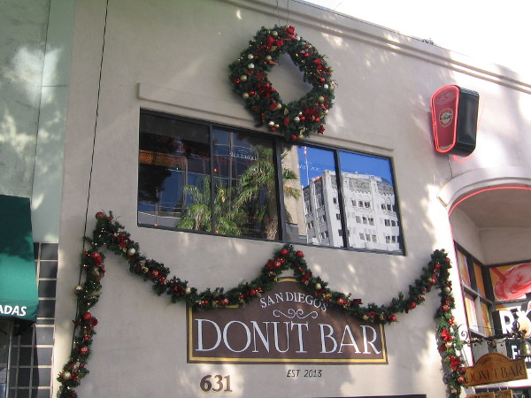Traditional holiday garland and colorful ornaments festoon the famous Donut Bar in downtown San Diego.