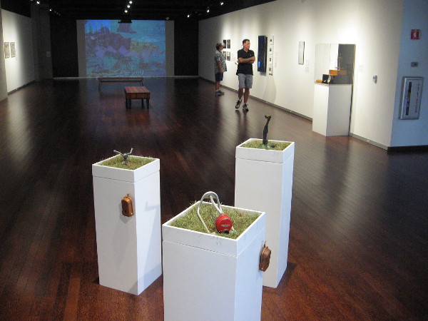Margaret Noble, I Have Arrived, 2015. Mixed media installation with 3 pedestals, 3 plant boxes, 3 sprinklers, and 3 handheld audio players. Lawns have been a symbol of status in society.