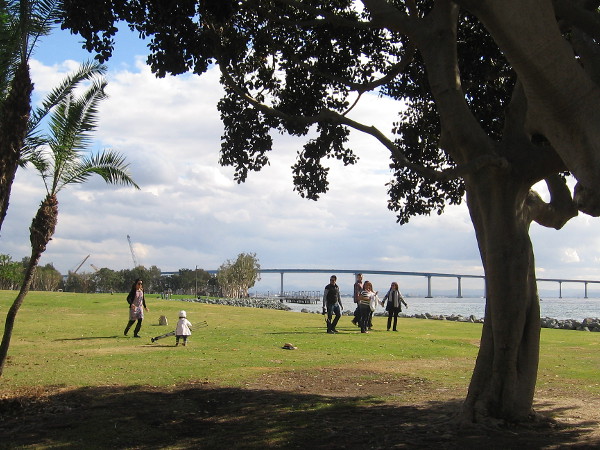 A helpful tot picks up a photographer's tripod after a photo shoot at Embarcadero Marina Park North.