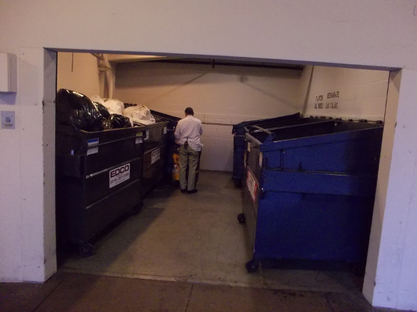 A building's dumpsters are ready to be hauled out and emptied.