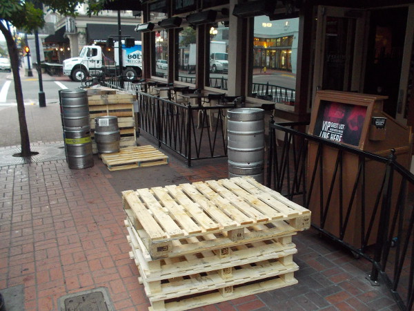 While garbage is collected, early morning deliveries are also being made, including kegs of beer on pallets.