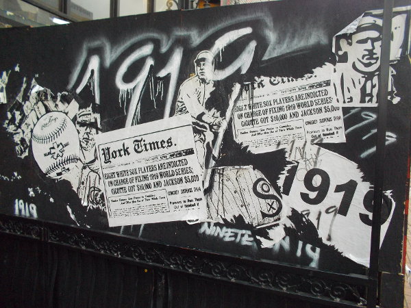 A collage of baseball scandals on a temporary construction wall in the Gaslamp Quarter.