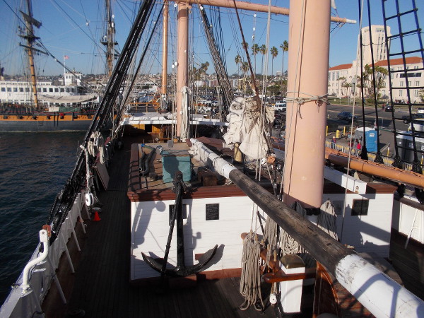 I believe that long timber supported by the forward house and forecastle is the top section of the foremast, which is being refurbished. But I might be mistaken.