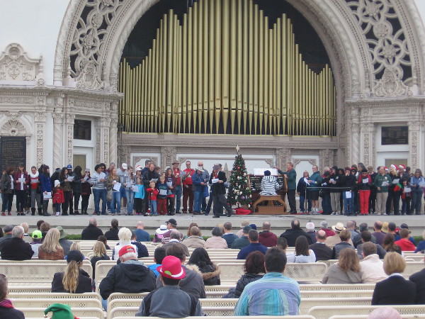 Ordinary people from San Diego and around the world gather in Balboa Park to sing Christmas carols at the Spreckels Organ Pavilion.