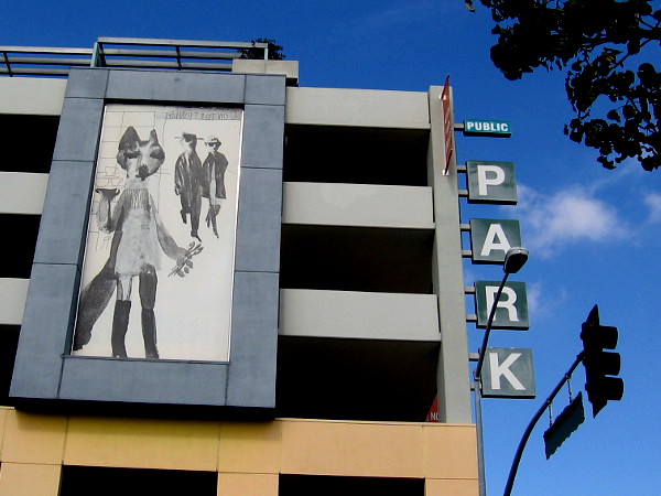 Looks like some sort of hip creature carrying a tray of glasses, and some spoons. I like the style of this artwork.