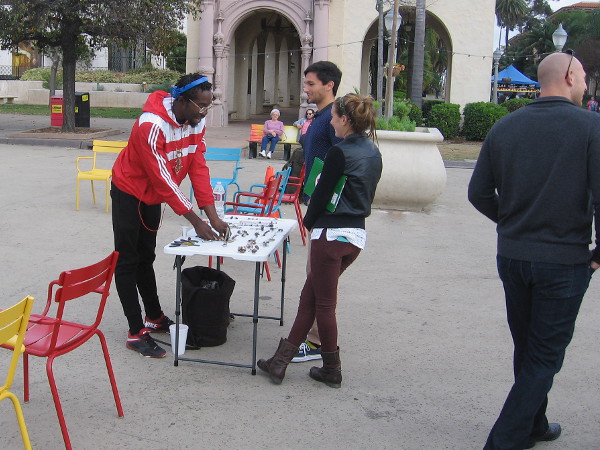Guy shows some people his stuff in the Plaza de Panama.