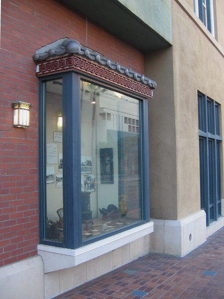 Three bay windows at the Dr. Sun Yat-sen Memorial Extension display historical photographs and common artifacts from San Diego's old Chinatown.