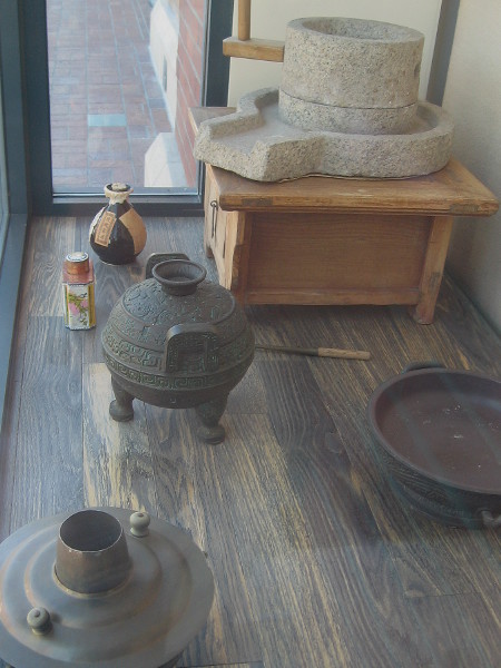 Display includes various articles used for food preparation and cooking in San Diego's old Chinatown.