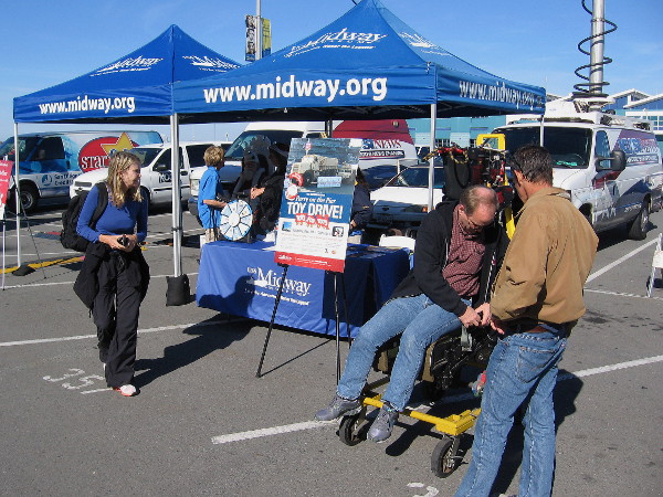 A guy checks out an ejection seat during the Toys for Tots toy drive on Navy Pier. I wonder if Santa has one of those on his sleigh?