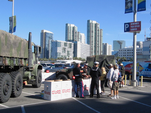 Marines collect toys to help spread holiday cheer, with downtown San Diego's skyline in the background.