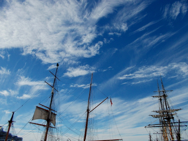 Tall ships under beautifully streaked clouds on a late December day in San Diego.