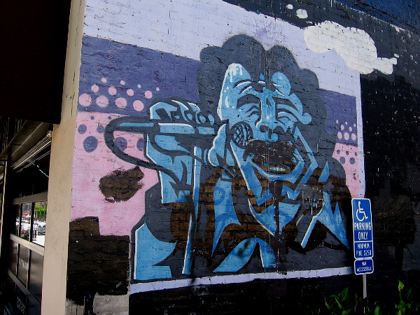 Street art on building of someone "singing the blues".