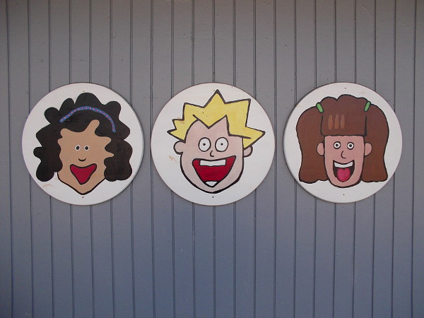 Funny faces peer from the wall of a local business on West Washington Street in Mission Hills.