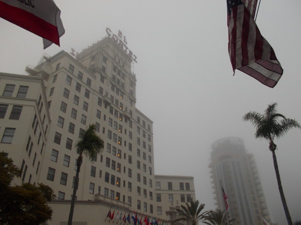Flags, palm trees and early morning fog on Cortez Hill in San Diego.