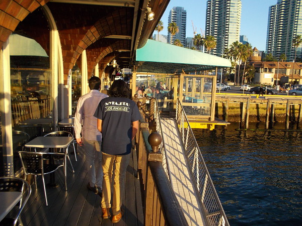 People walk along narrow outdoor deck of Anthony's Fishette, a popular casual dining spot for half a century in downtown San Diego.