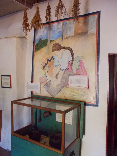 Art on one wall depicts the grinding of corn. Other nearby maps and graphics show how food is related to our city's history.