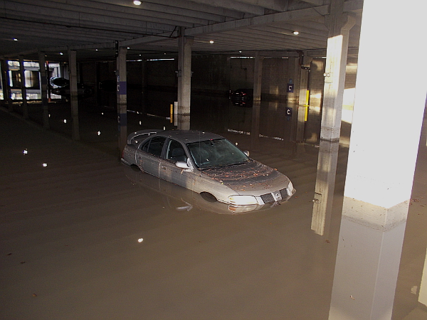 Car deep in the water. The flooded lower level of a Fashion Valley parking garage in San Diego's Mission Valley.