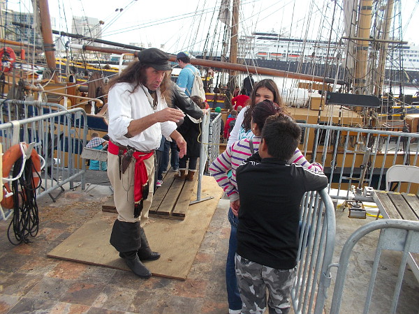 Captain Swordfish makes a scene, distracting those who are boarding the Lady Washington. Nobody notices what that first innocent-looking pirate is up to.