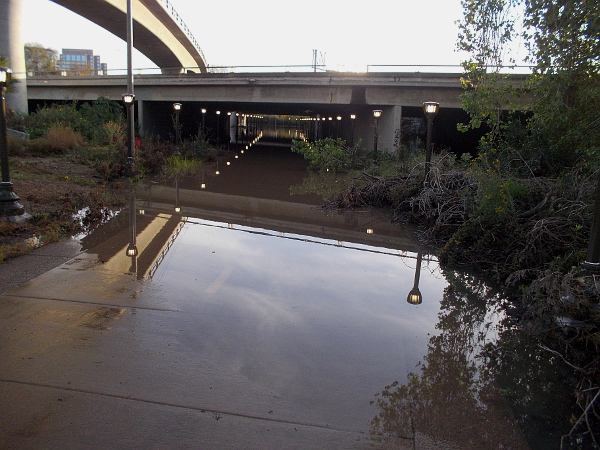 The bike and pedestrian pathway beneath Highway 163 flooded and was impassable. The nearby river was swollen with the recent rain.