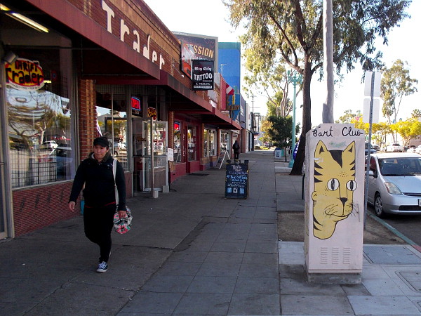 Looking down San Diego's busy El Cajon Boulevard past some imaginative Bart Club street art.