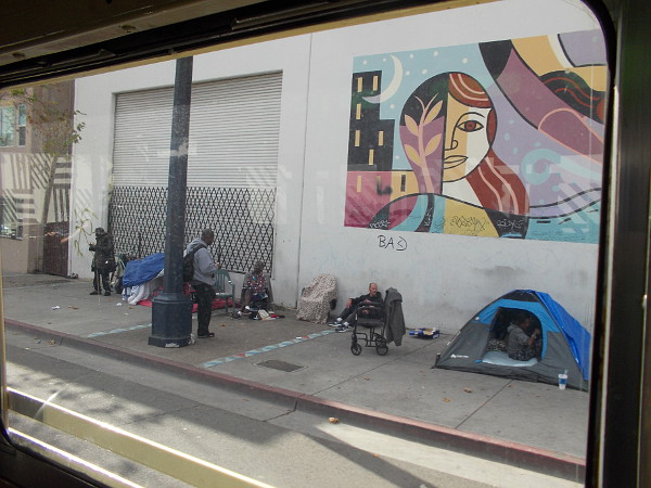 Heading down Park Boulevard, and people camped on the sidewalk. San Diego, unfortunately, contains many homeless.