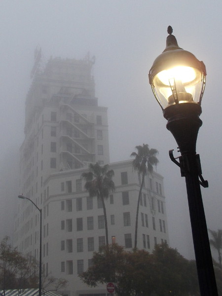 The historic El Cortez Hotel seems to vanish into the gray morning fog.