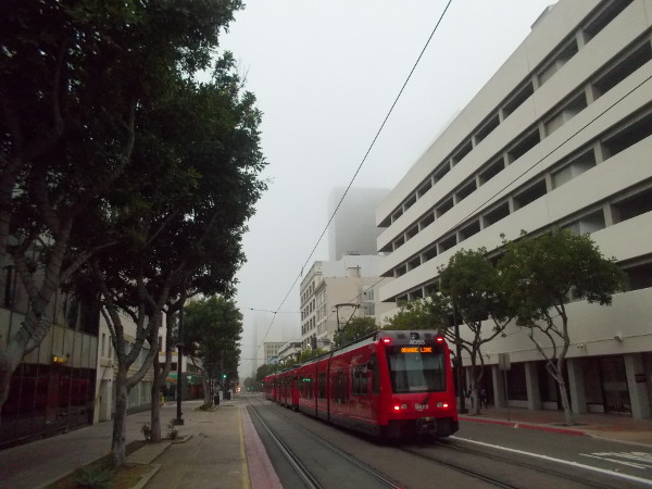 An Orange Line trolley heads down a quiet C Street.