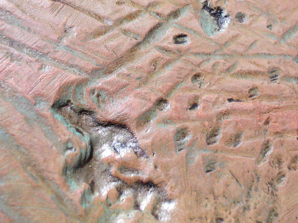 A closer view reveals craters and furrows. Small glimpses of beauty within a larger whole.